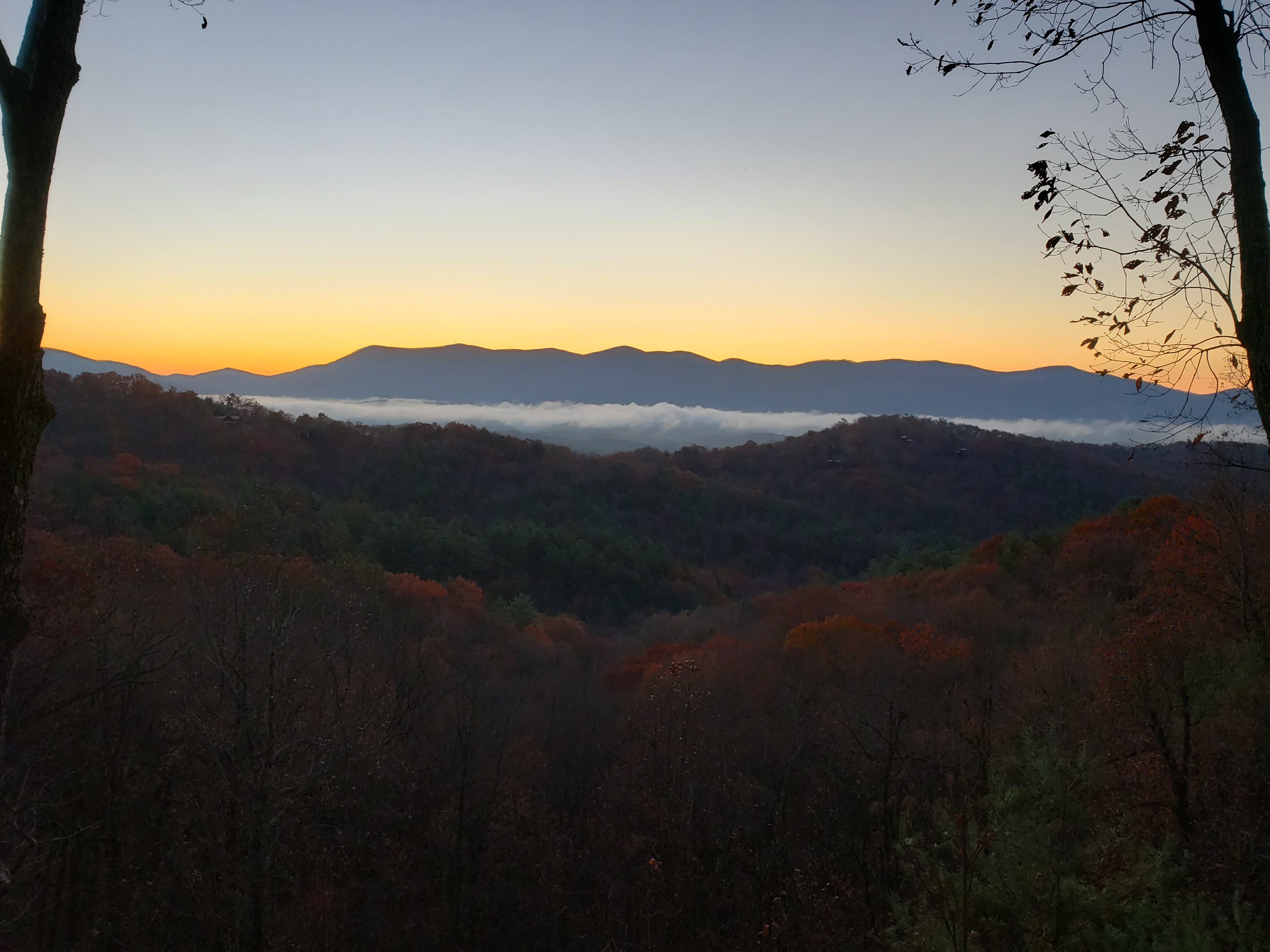A quiet late-fall mountain view with soft evening color.